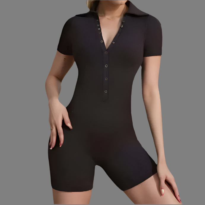 Woman wearing a tight black jumpsuit with short sleeves. Features relaxed fit and breathable organic cotton material.