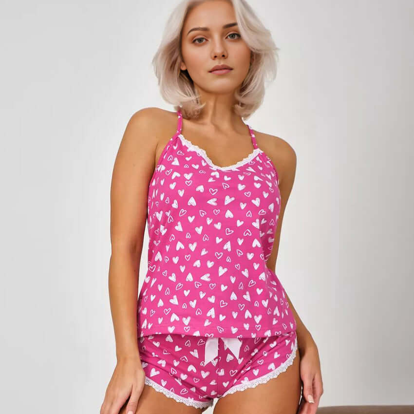 Pink heart-patterned suspender shorts pajamas suit. Organic cotton, relaxed fit. Breathable material for comfortable sleepwear.