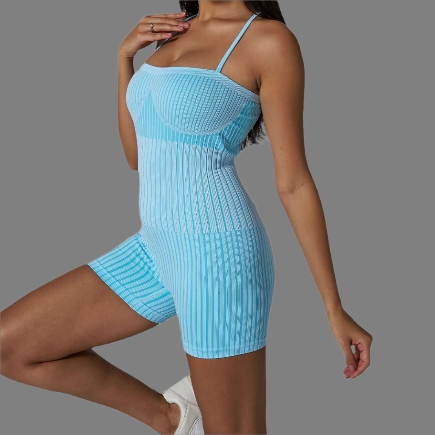 Ribbed strappy bodysuit in light blue. Made from organic cotton for a relaxed fit. Features breathable material for comfort.