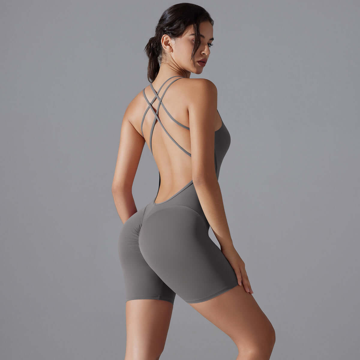 Woman wearing shaping one-piece shorts made of organic cotton. Relaxed fit, breathable material, perfect for yoga.