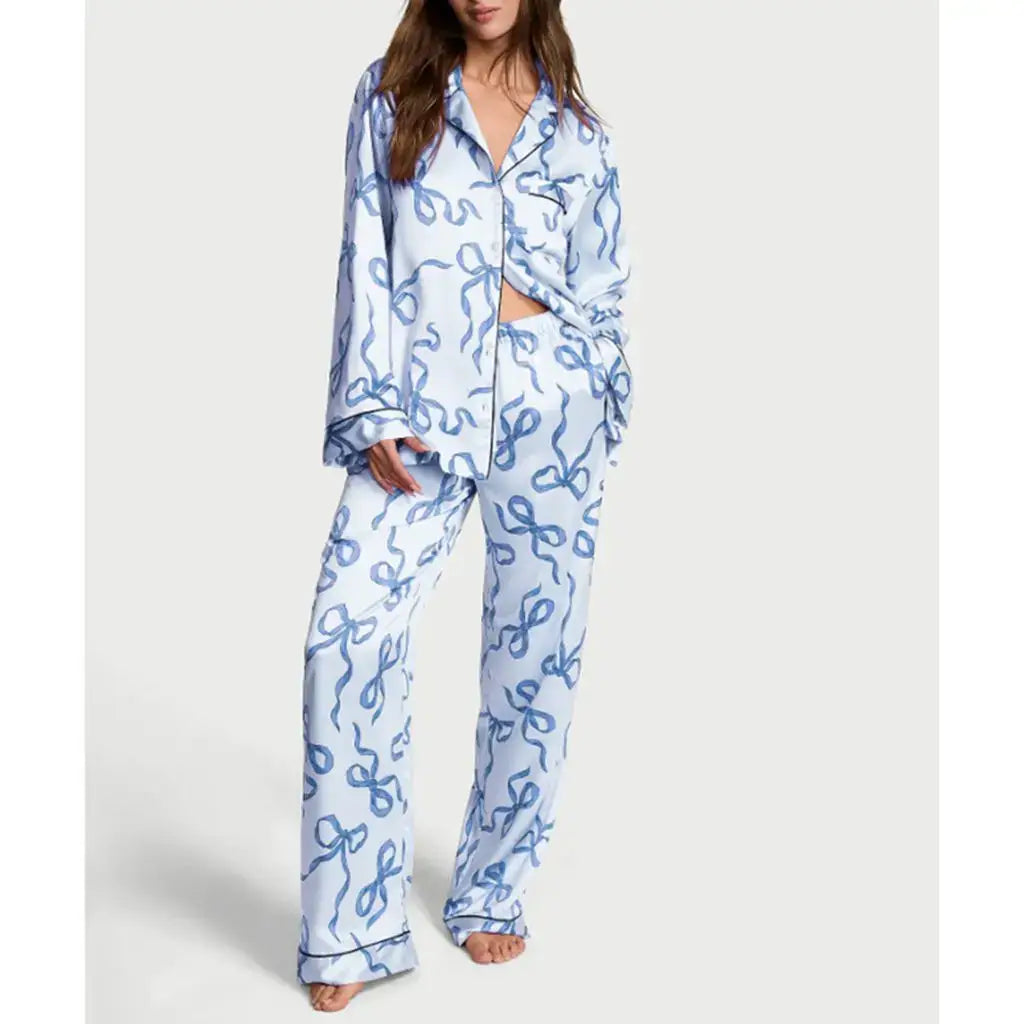 Woman wearing 2Pcs satin pajamas made from organic cotton. Features a relaxed fit with breathable material for comfort.