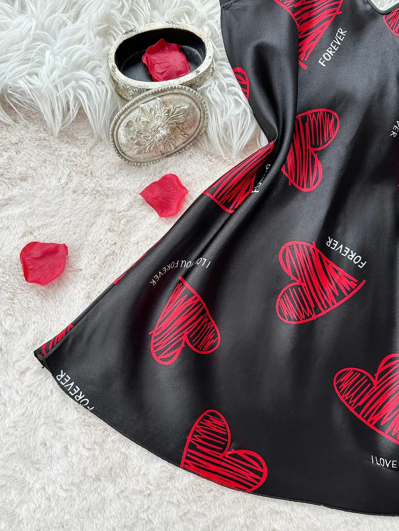 Red Lip Print Satin Slip with heart design, made with organic cotton. Features a relaxed fit and breathable material.