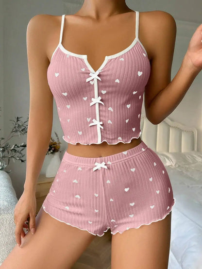 2-Piece Bow Sleepwear Set in pink. Made of organic cotton. Features a relaxed fit and breathable material for comfortable nights.