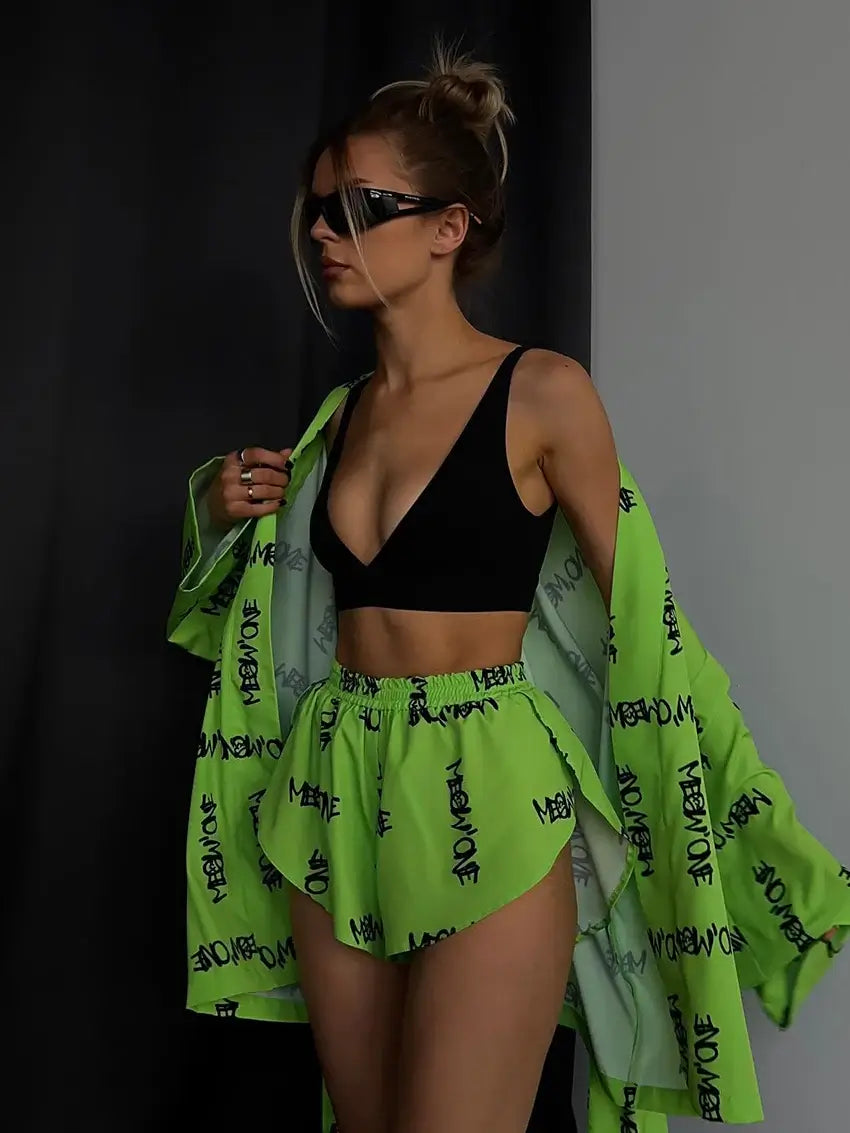 Model wearing green loose long robe and shorts set. Made of organic cotton with relaxed fit. Breathable material.