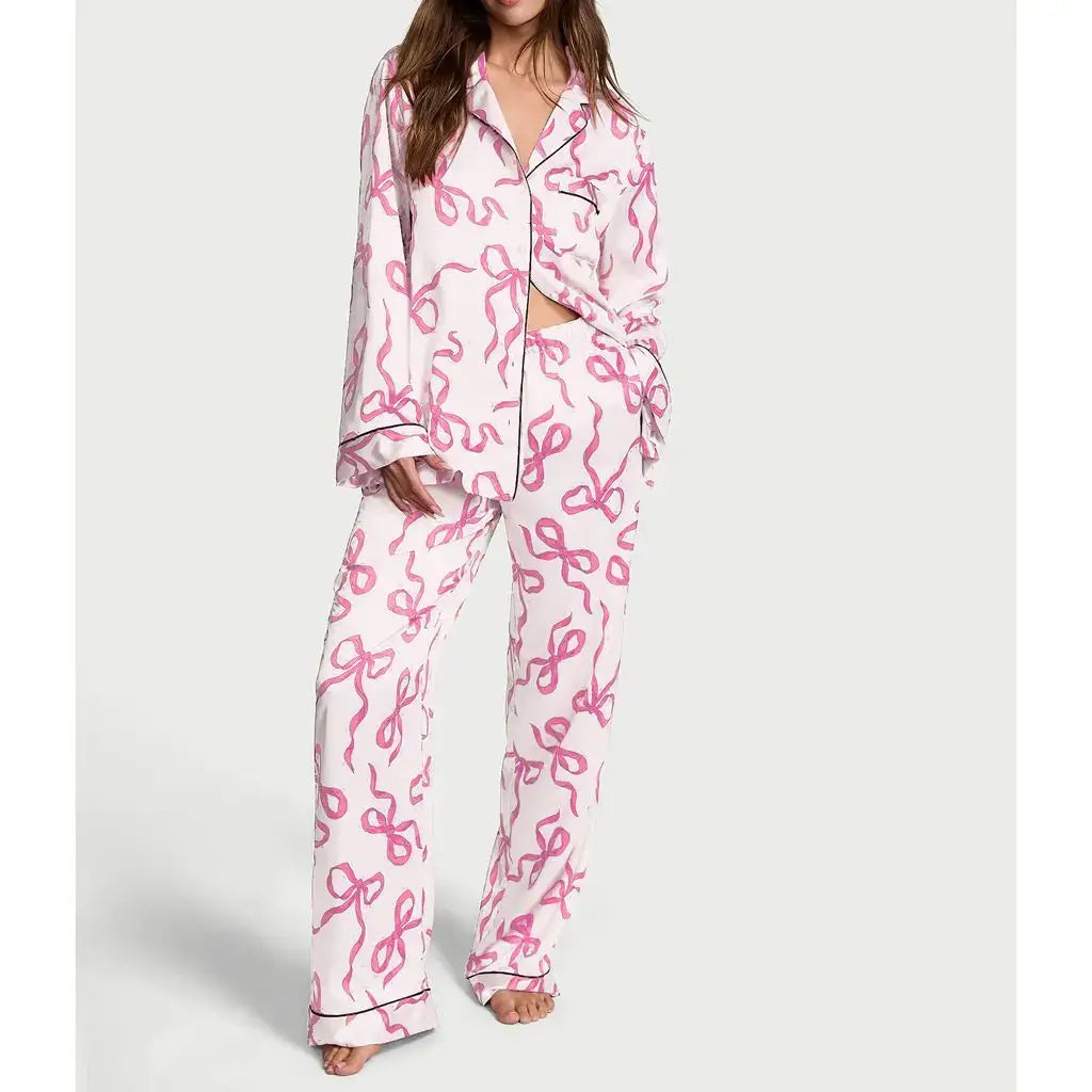 Alt Tag: Woman wearing 2-piece satin pajamas with pink ribbon pattern, made from organic cotton. Relaxed fit, breathable material.