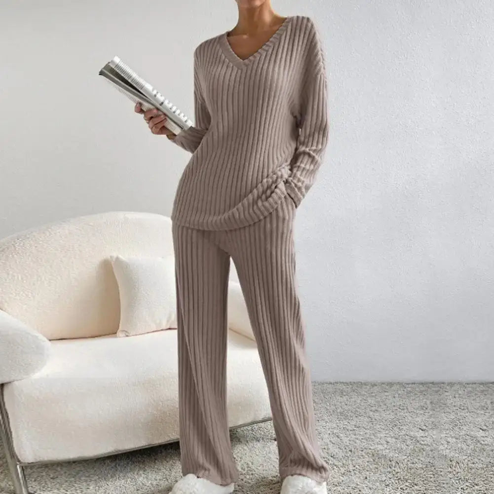 Woman wearing organic cotton knitted lounge set pajamas. Relaxed fit, breathable material. Perfect for cozy comfort.