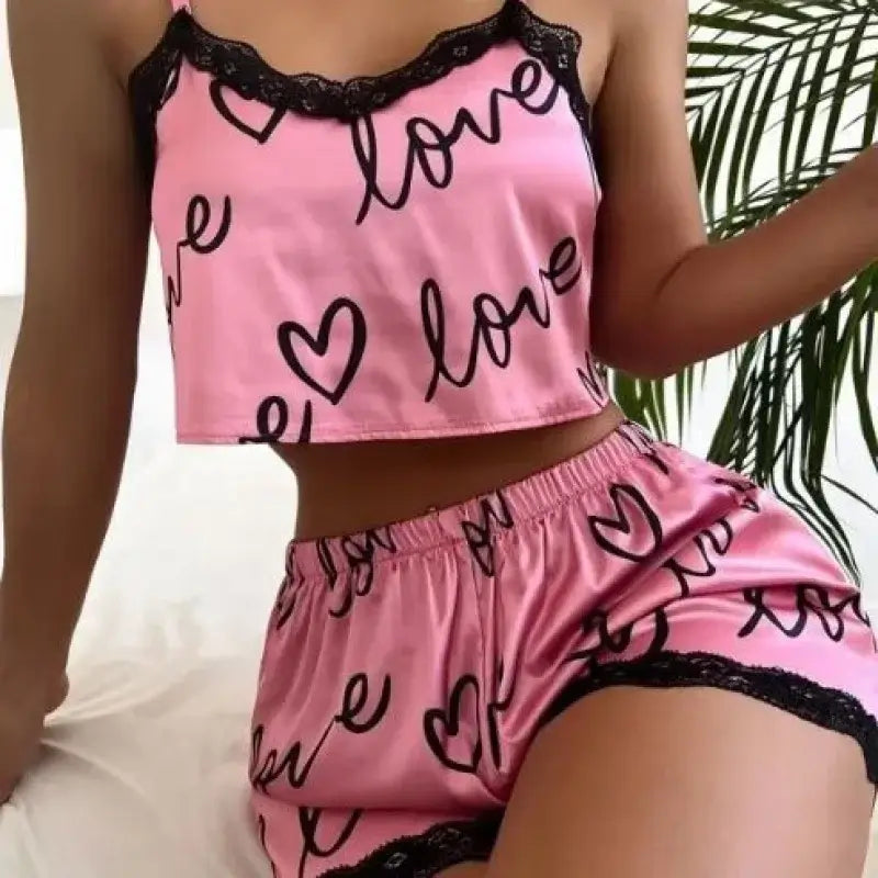 Organic cotton two-piece set in pink with love print. Relaxed fit and breathable material for comfort.