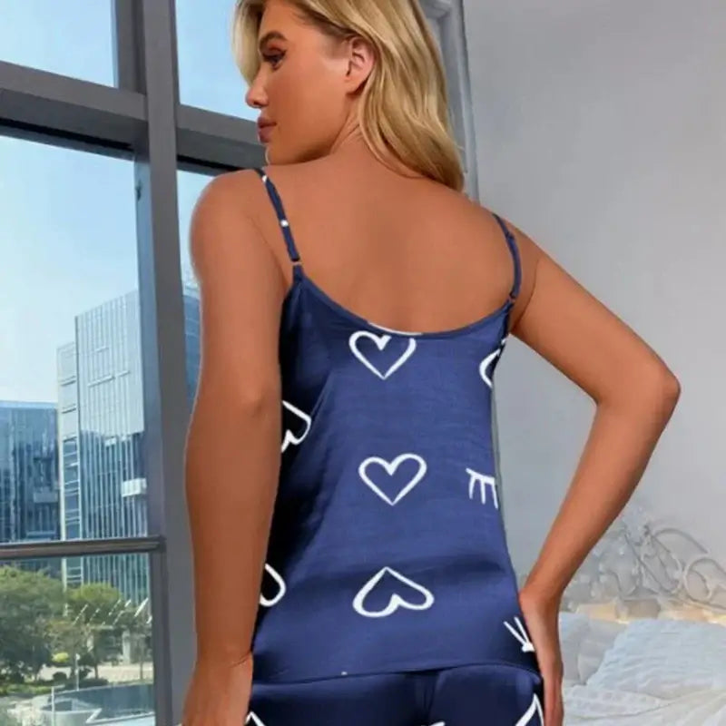 Back view of Dreamy Satin Silky Sleepwear Set in navy with heart patterns. Made of organic cotton, offering a relaxed fit and breathable material.