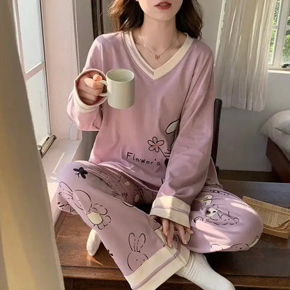 Woman in relaxed fit, organic cotton pajamas with floral print, enjoying a cup of coffee, showcasing breathable material.