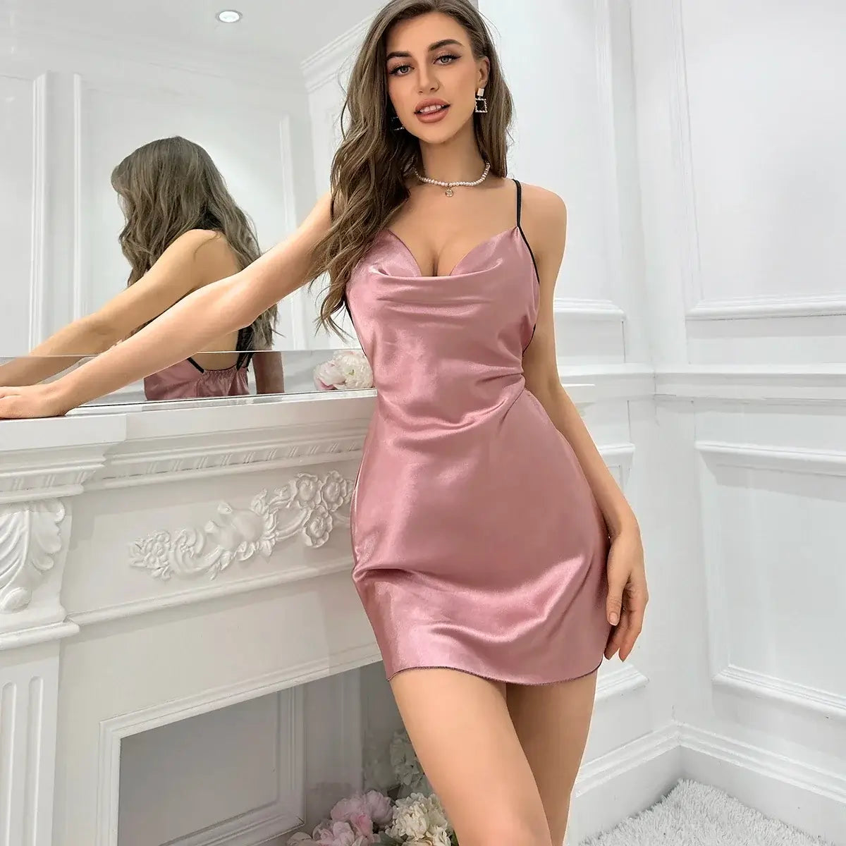 Alt Tag: Woman wearing pink nightdress with relaxed fit. Made from organic cotton, breathable material. Elegant and comfortable.