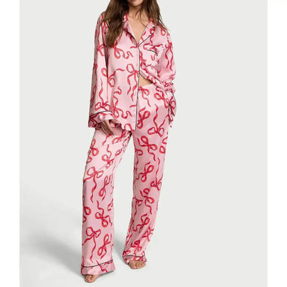 Organic cotton pink satin pajamas, relaxed fit. Breathable material for comfort. Two-piece sleepwear set with stylish design.