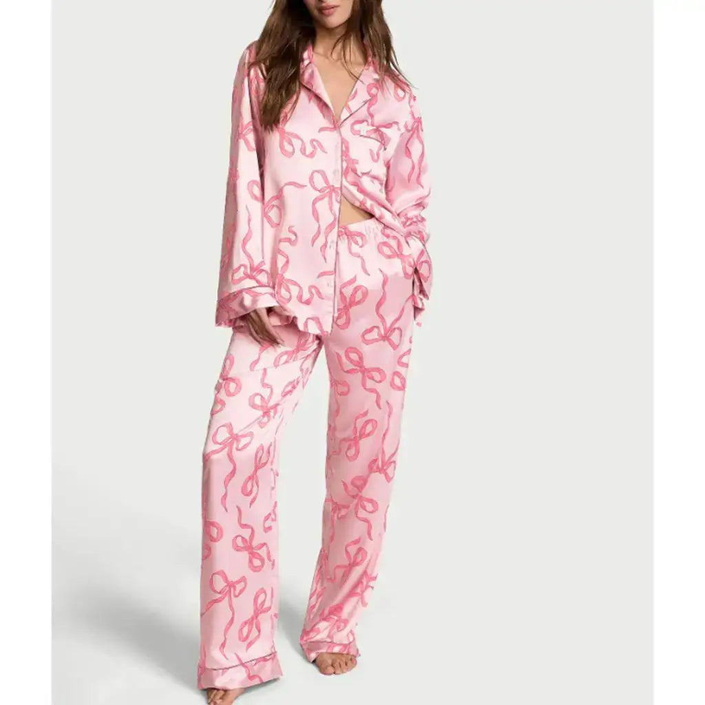 Woman in pink satin pajamas set. Organic cotton. Relaxed fit. Breathable material.