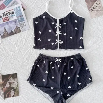 2-piece bow sleepwear set in organic cotton. Relaxed fit with breathable material. Stylish heart patterns, ideal for comfort.