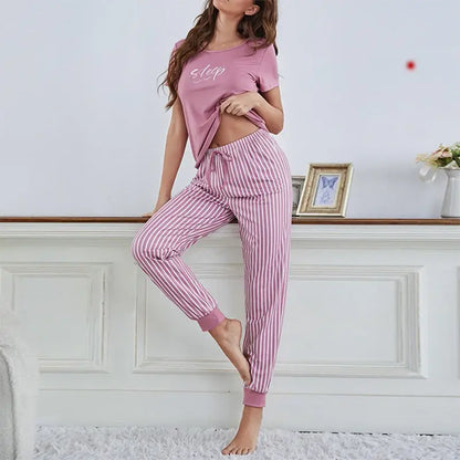 Woman wearing organic cotton sleepwear in pink, showcasing a relaxed fit and breathable material.