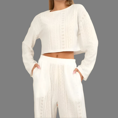 Woman wearing relaxed fit, organic cotton long sleeve top and trousers. Breathable material in creamy white shade.