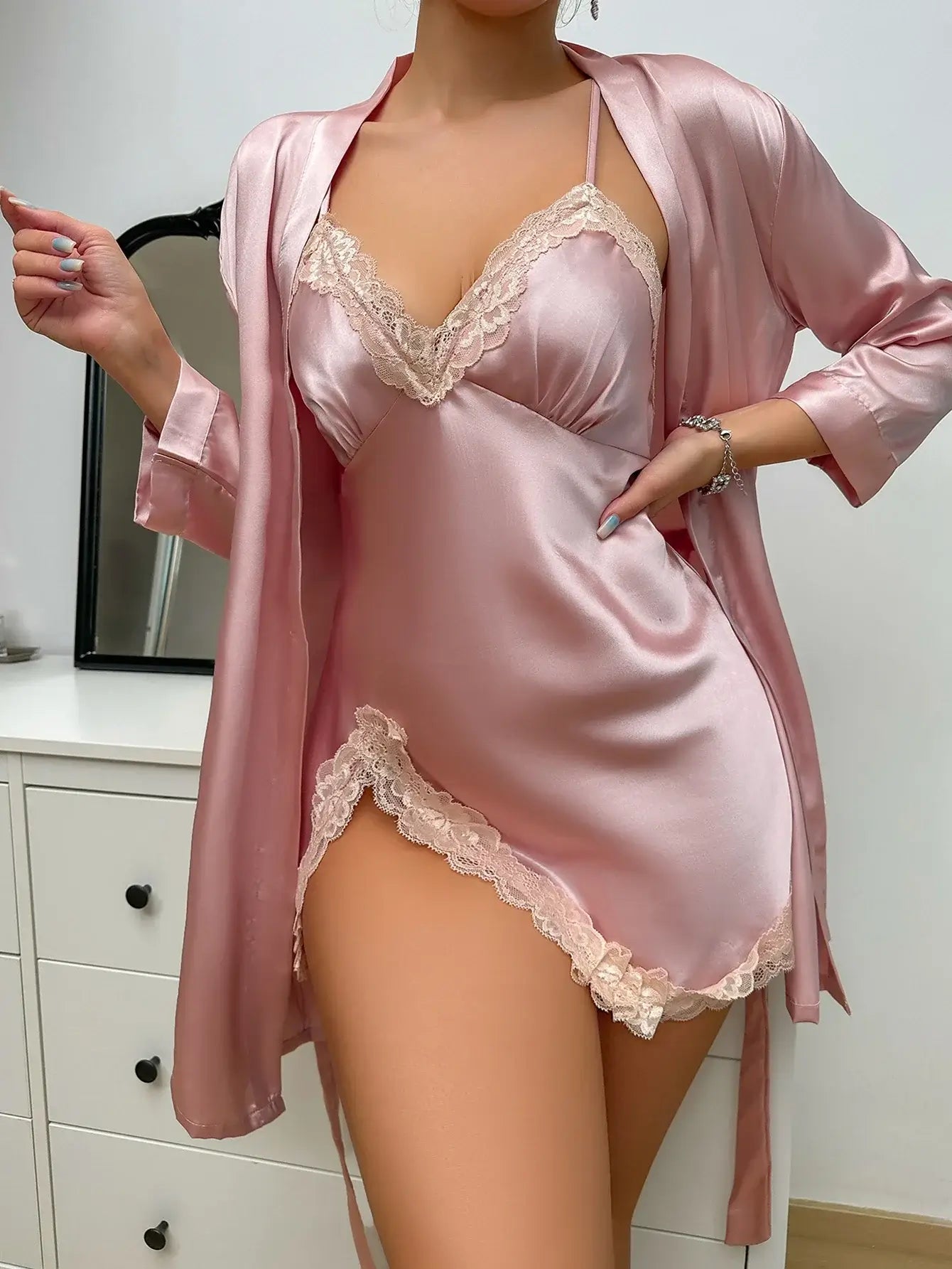 Luxury lace nightdress set in organic cotton. Relaxed fit and breathable material. Elegant pink design with lace detailing.